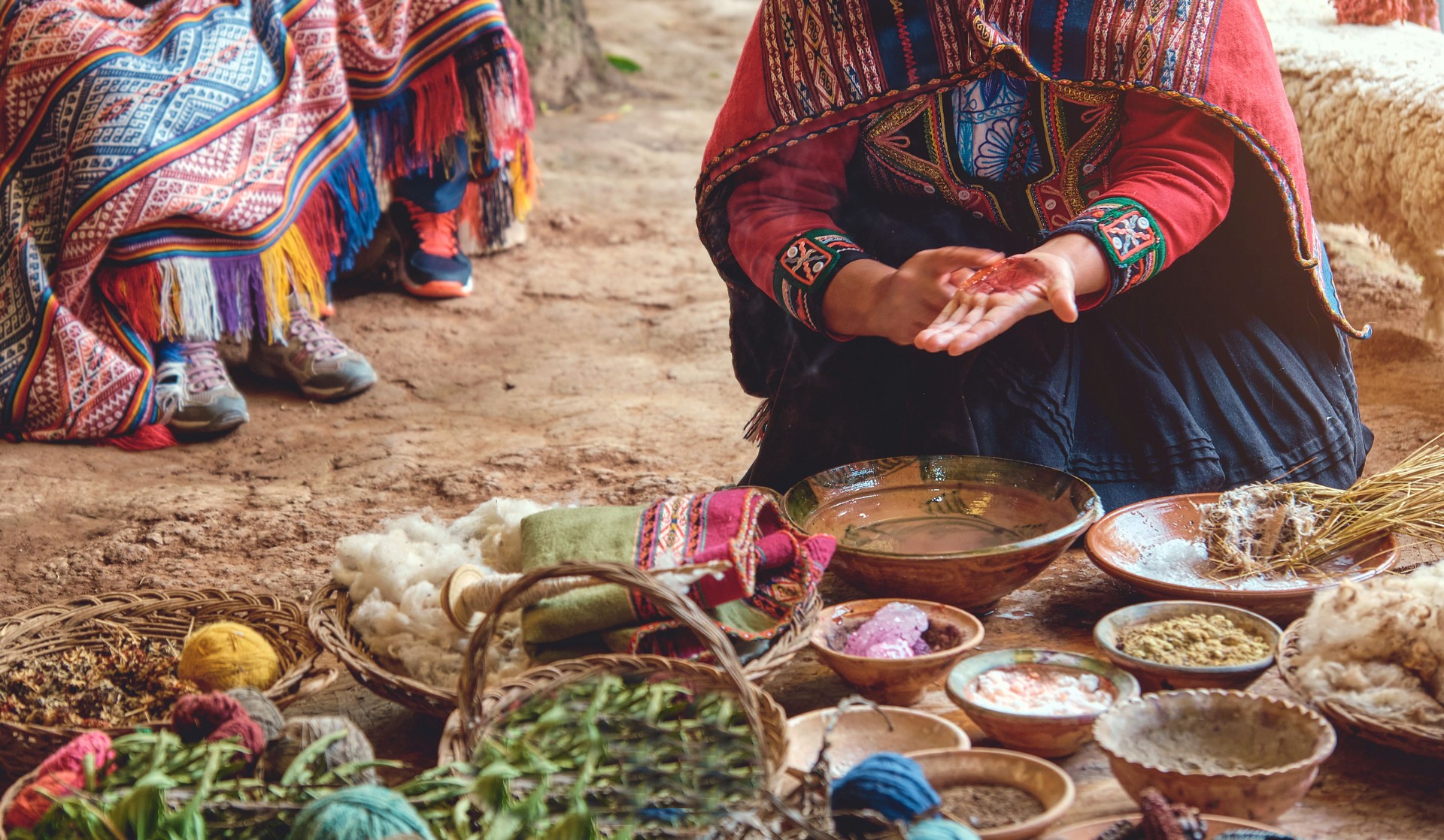 Andean woman working in traditional Inca wool handicraft production. Traditional pigment material used by the incas.