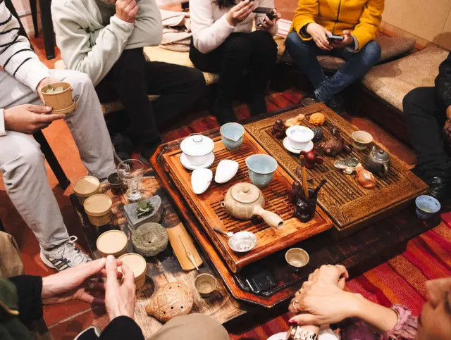 Guests' hands on the tea table